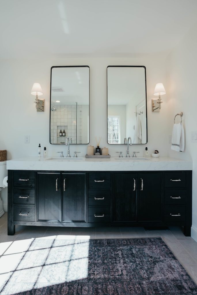 master bathroom with black vanity and double sinks