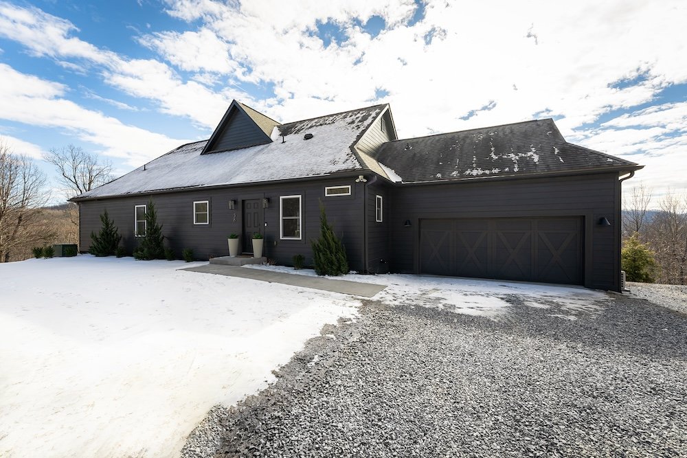 newly remodeled home with dark paint on the exterior
