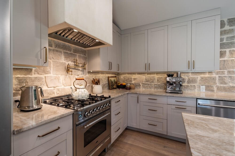 new farmhouse kitchen with wood backsplash and white cabinets