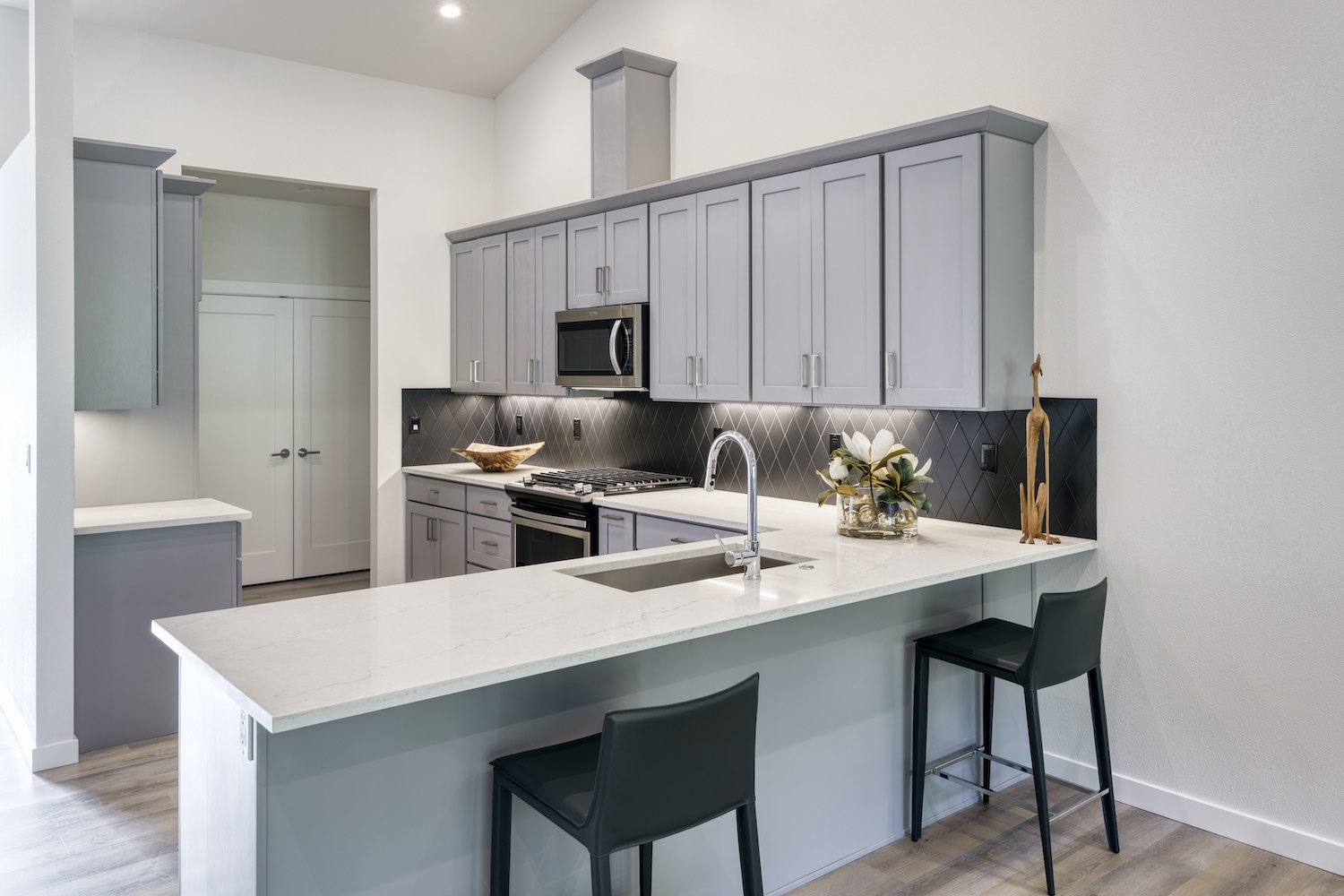 kitchen with white countertops and grey cabinets