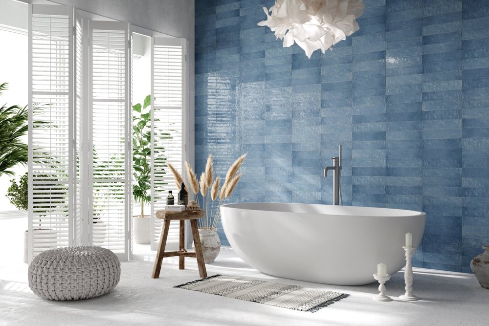 bathroom with blue wall tiles, soaking tub, and white shutters